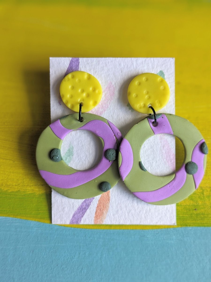 Large statement dangly earrings, bright yellow with green and purple detail