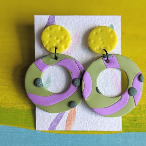 Large statement dangly earrings, bright yellow with green and purple detail