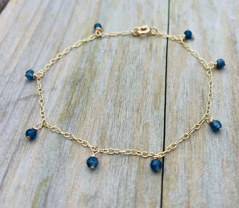 9ct gold bracelet with small faceted sapphire charms