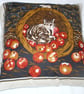 A brown tabby cat in a basket of apples cushion - Image 1