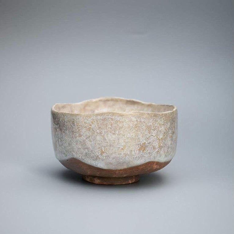A crystalline stoneware ceramic bowl, a hand made pinch pot with a whitesilver c
