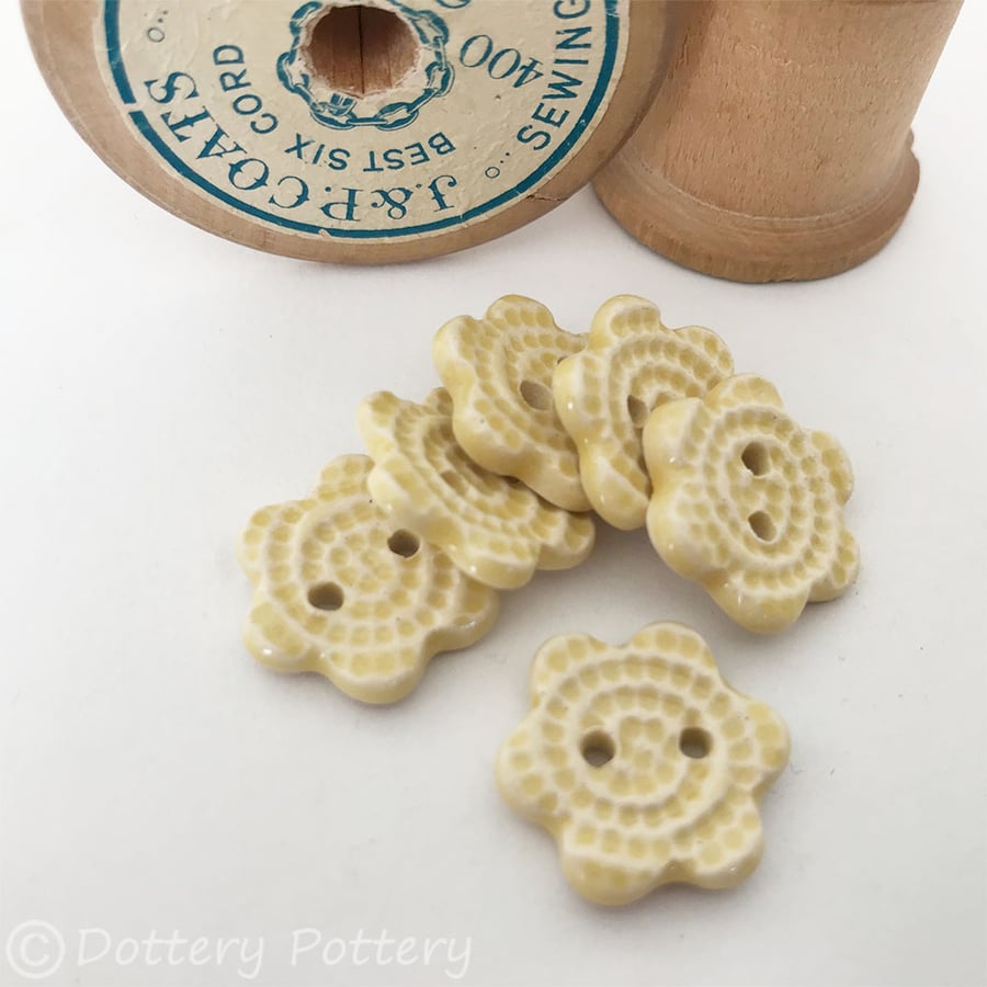 Set of six yellow flower shaped ceramic handmade buttons