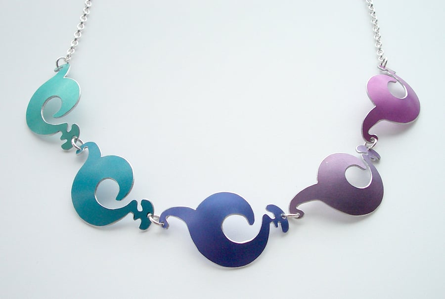 Spiral shapes necklace in purples blues and pinks