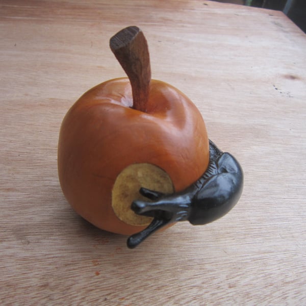 wooden apple with a slug