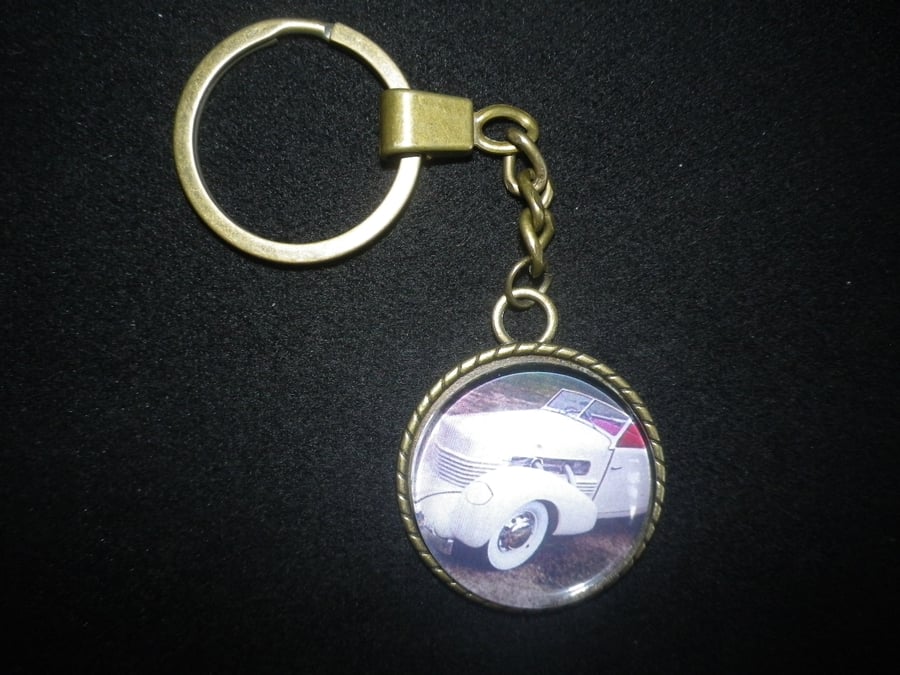1937 Cord Cabriolet keychain,lovely shape,30mm (1.25") image,vintage setting