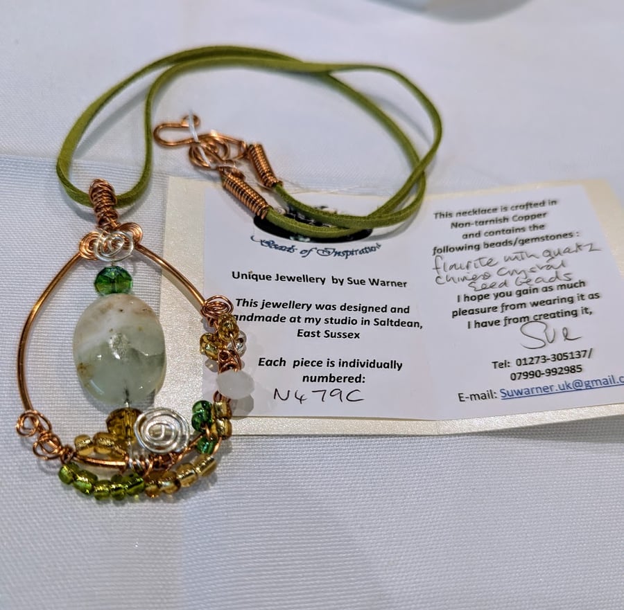 A fluorite & quartz oval hang from a non-tarnish copper pendant (N479C)