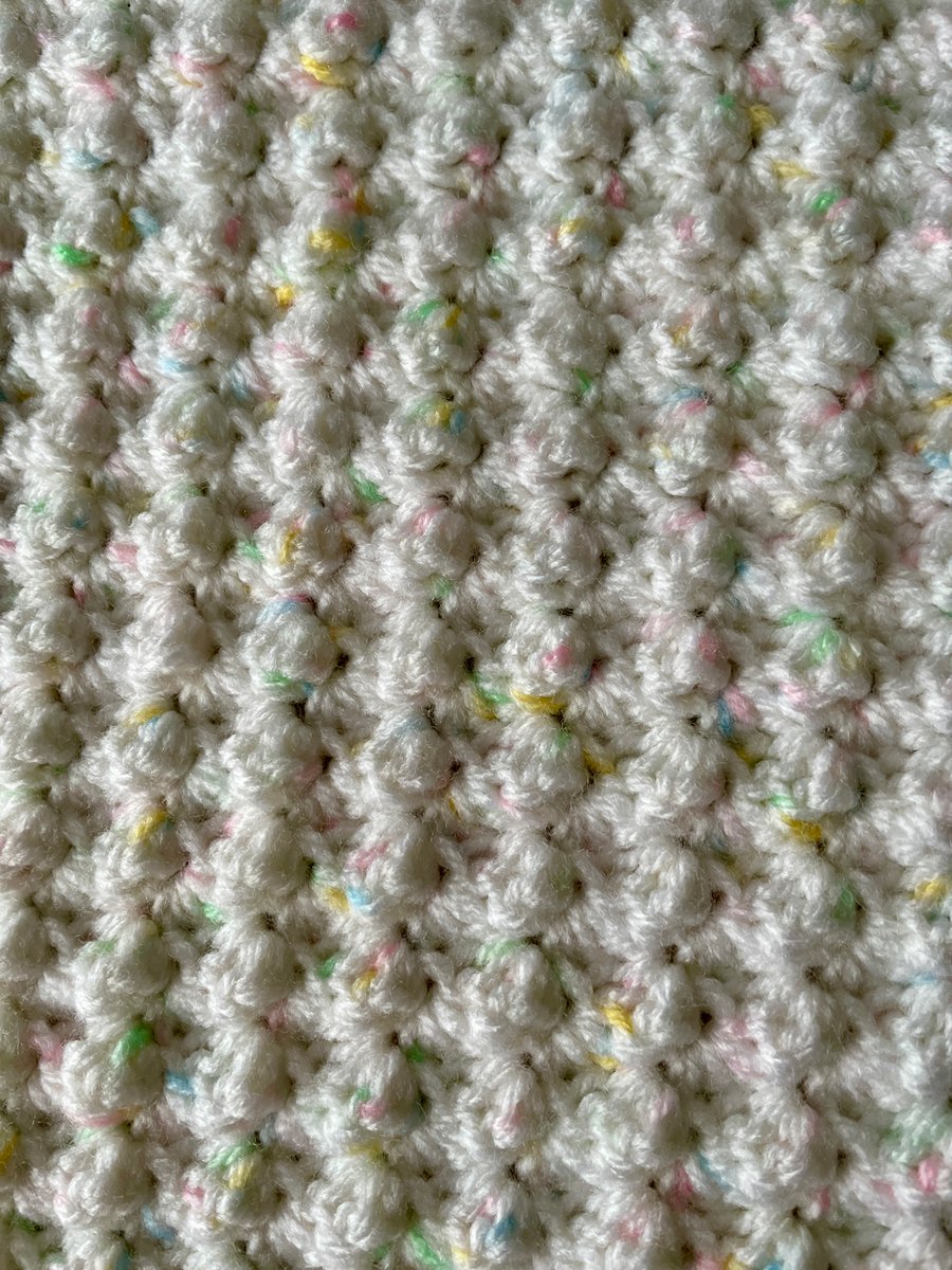 Hand Crochet Baby Blanket in White with pastel coloured highlights