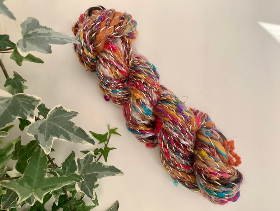 Hand spun art yarn. Corriedale, merino, cotton, and wool locks blend. 