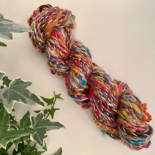 Hand spun art yarn. Corriedale, merino, cotton, and wool locks blend. 