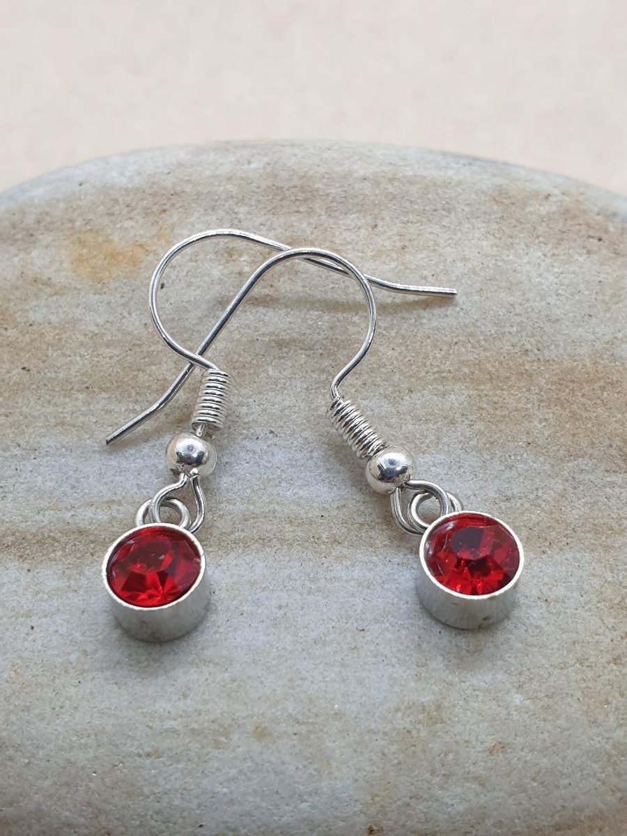 sweet little silver plated earrings with mini red glass pendants