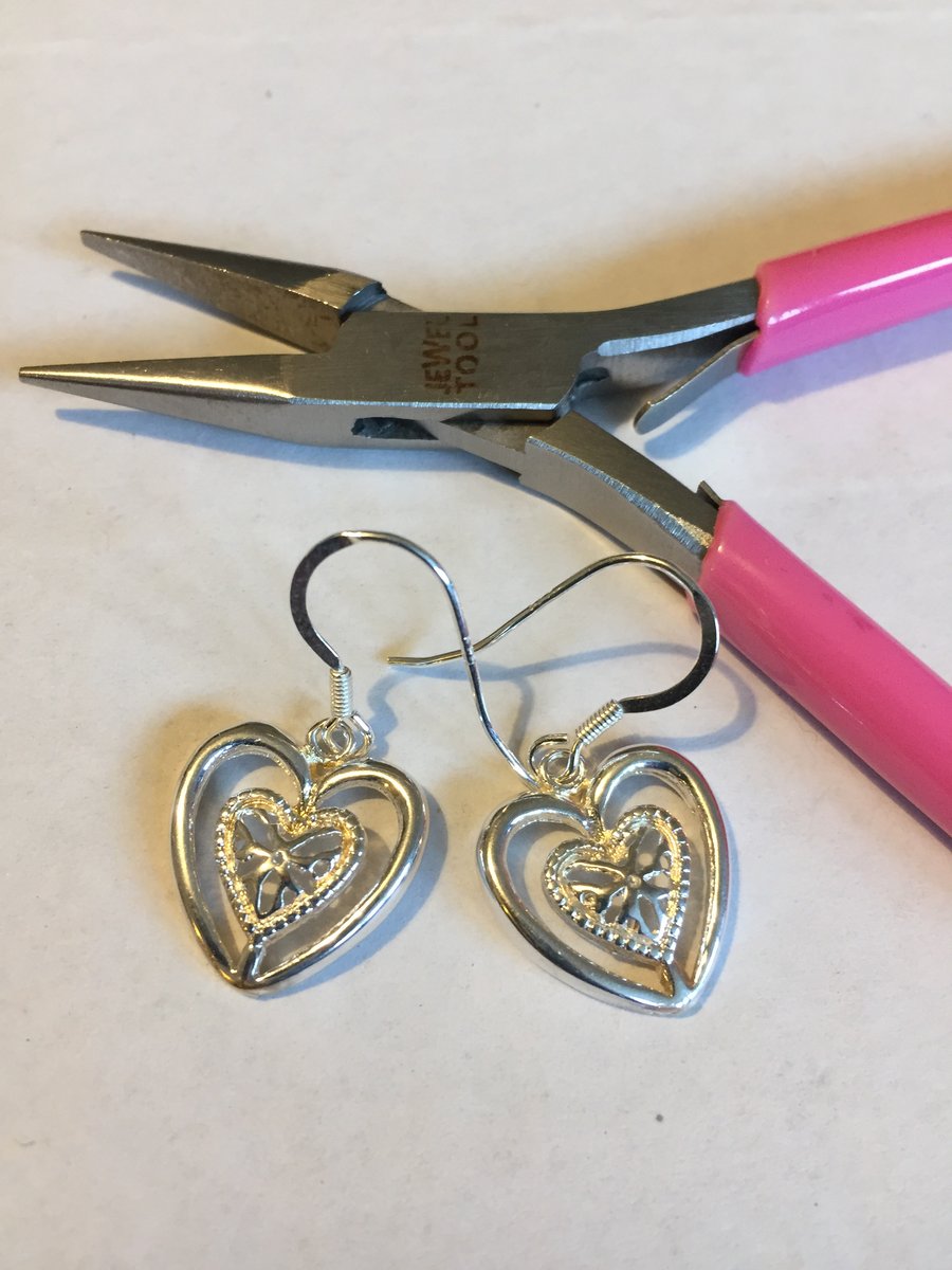 Silver heart shaped earrings made from a broken bracelet