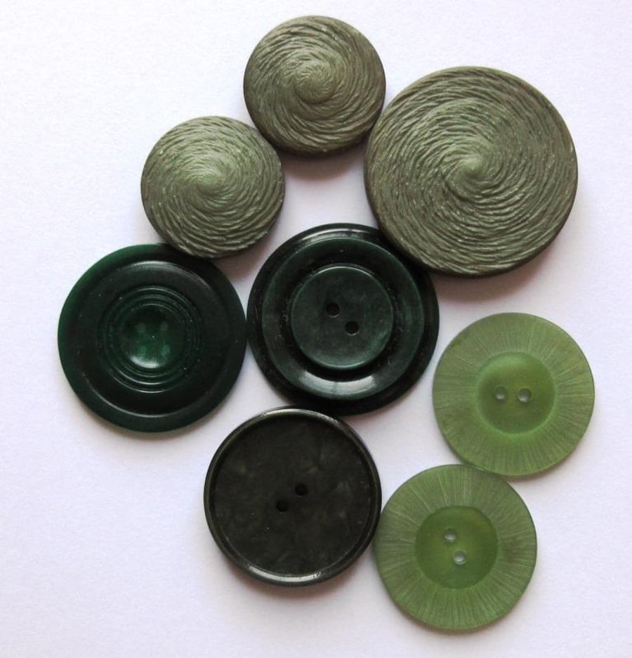 A collection of vintage large and medium-sized buttons in shades of green