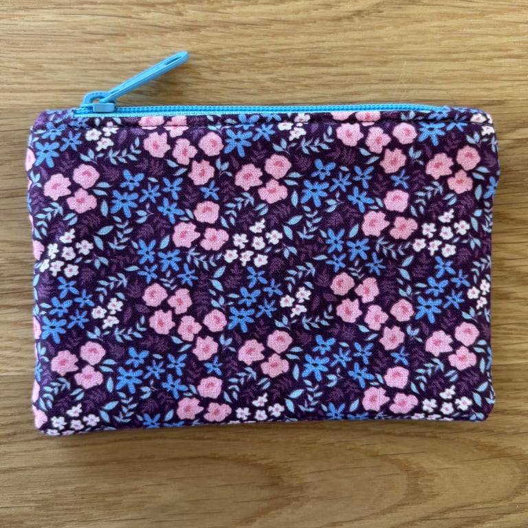 Small zipped fabric coin purse, pouch, in purple, pink & blue floral print.