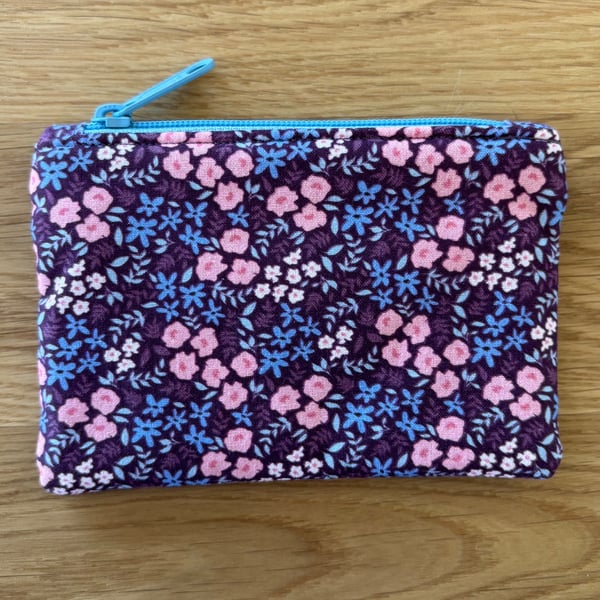 Small zipped fabric coin purse, pouch, in purple, pink & blue floral print.