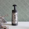 Tillie.  Tiny bottle form in matt black stoneware ceramic with seedhead motifs.