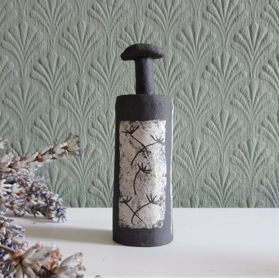 Tillie.  Tiny bottle form in matt black stoneware ceramic with seedhead motifs.