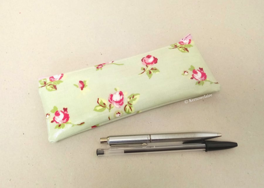 Pencil case in pale green oilcloth with small pink flowers