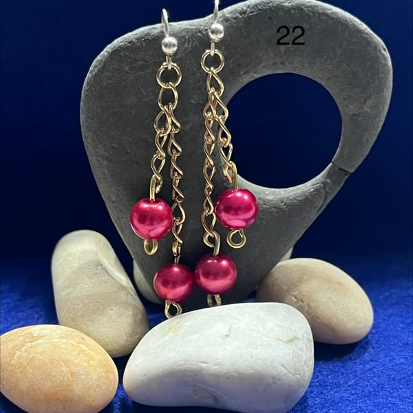 Beautiful earrings made from gold coloured chain and pink beads.
