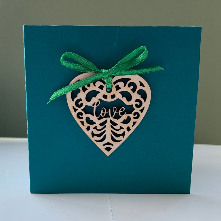 Blank card with detachable wooden 'love' heart decoration