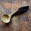 Hand carved oak wooden spoon featuring eye-catching bark handle