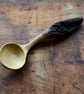 Hand carved oak wooden spoon featuring eye-catching bark handle