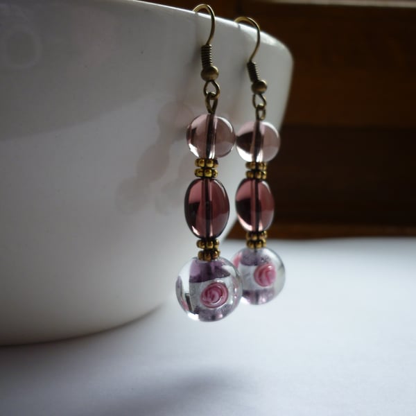 AMETHYST, PINK, SILVER AND BRONZE LAMPWORK BEAD EARRINGS.