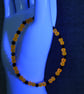 UV Reactive Orange Glass Bead and Black Glass Bicone Elastic Bracelet - Image 6