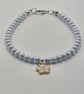 Pearl blue seed bead bracelet with small white flower charm - Image 4