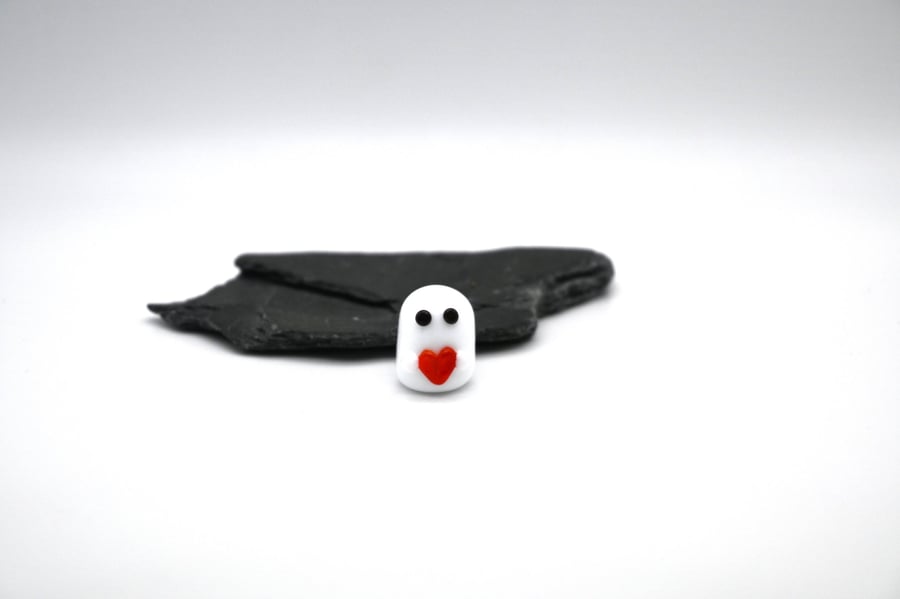 small glass ghost with red heart
