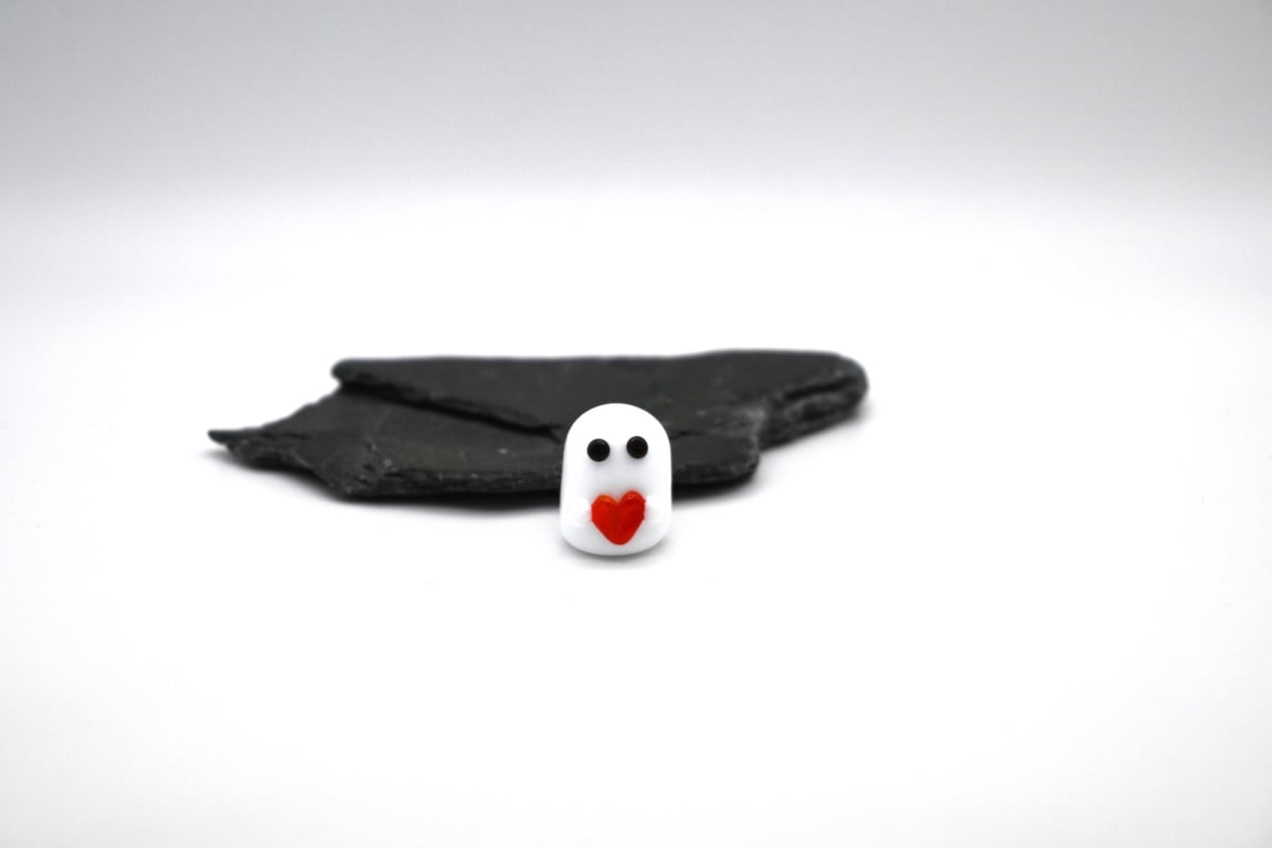 small glass ghost with red heart