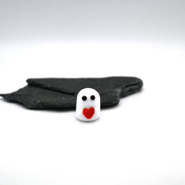 small glass ghost with red heart