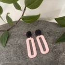 Statement earrings in pale pink and black 