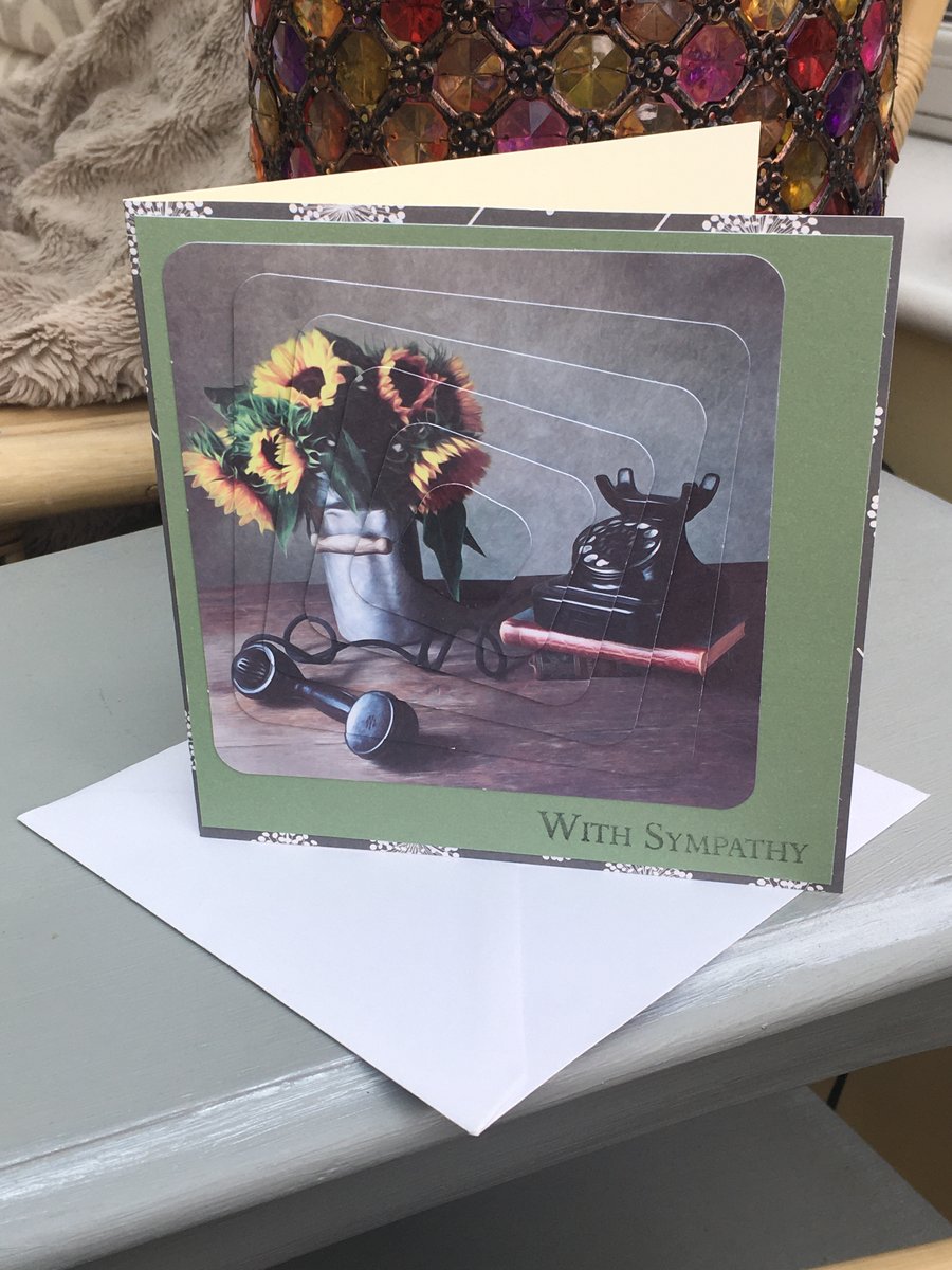 With sympathy card with sunflowers, telephone and dandelion seedheads.
