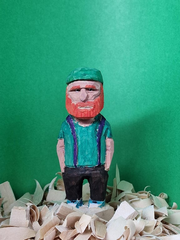Hand carved wooden figure Mac the school caretaker.