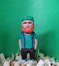 Hand carved wooden figure Mac the school caretaker.