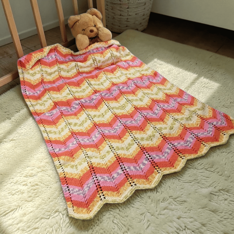 Hand knitted baby pram blanket - multi colour chevron 