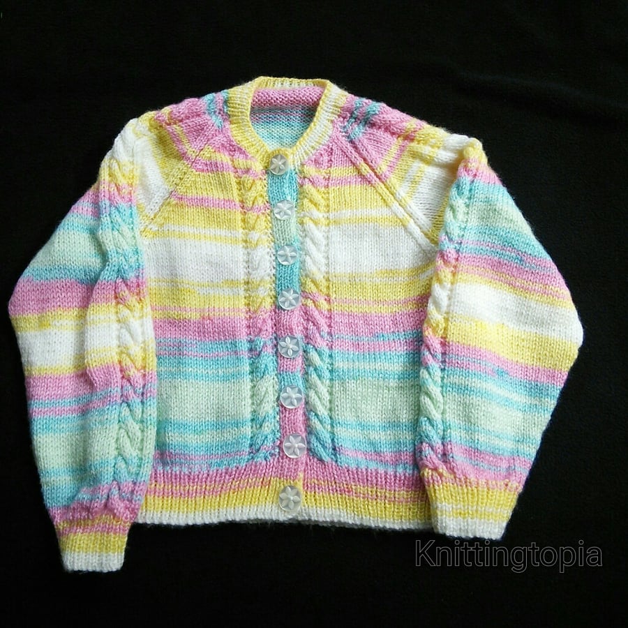 Baby cardigan hand knitted in multicoloured yarn with cable panel detail