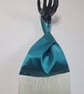 Teal green satin Japanese knot bag with 30cm cream tassel fringe.