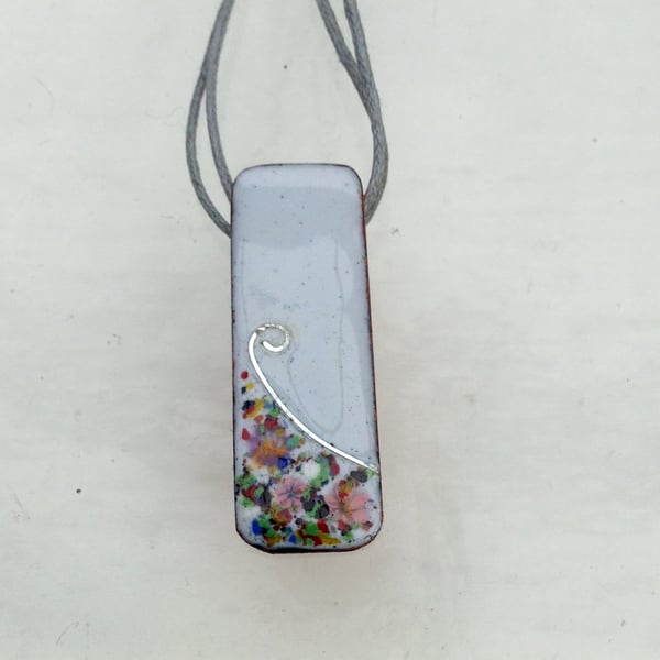 SMALL, SLIM, OBLONG FLORAL ENAMELLED PENDANT WITH STERLING SILVER DESIGN