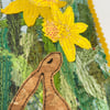 Upcycled embroidered spring rabbit and daffodil home decoration. 