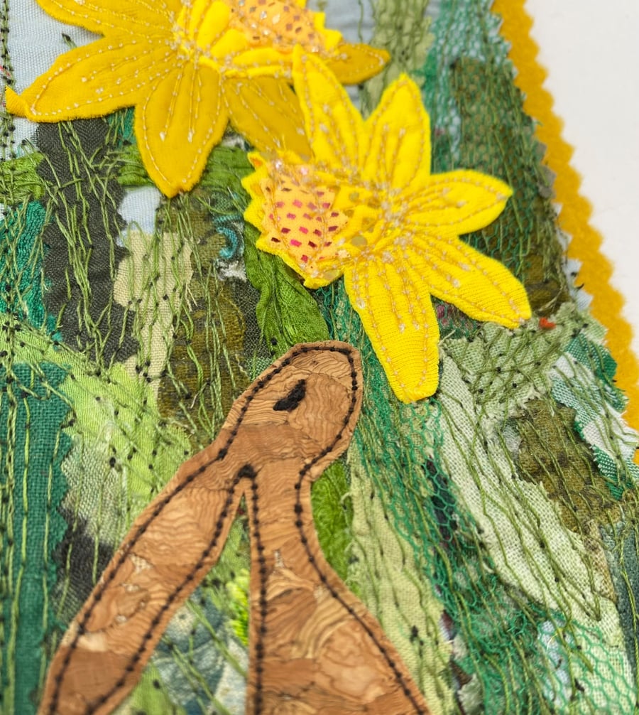 Upcycled embroidered spring rabbit and daffodil home decoration. 