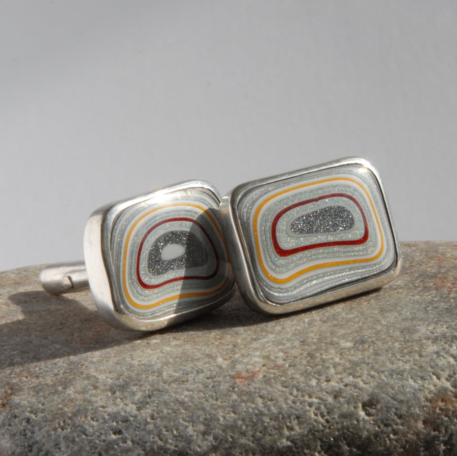 Red and yellow oblong fordite and sterling silver swivel back cufflinks