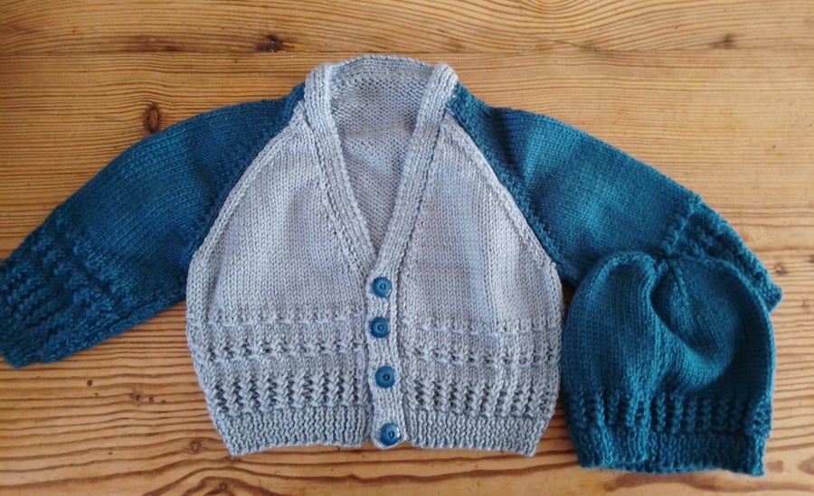 Handmade baby cardigan and hat set.