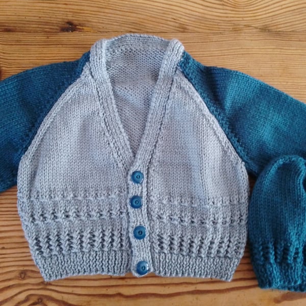Handmade baby cardigan and hat set.