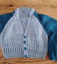 Handmade baby cardigan and hat set.