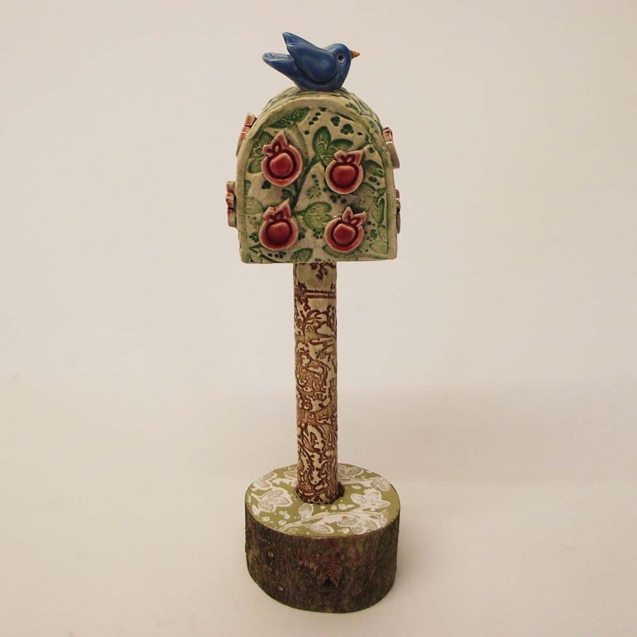 Pottery bird in an apple tree Ceramic sculpture