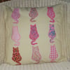 Appliqued cushion with pink cats