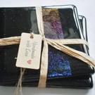 A pair of fused glass coasters with rainbow iridised strip