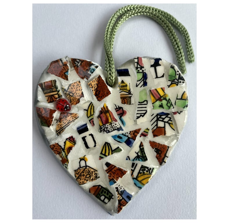 A lovely heart shaped mosaic pendant a brown, blue, green theme.