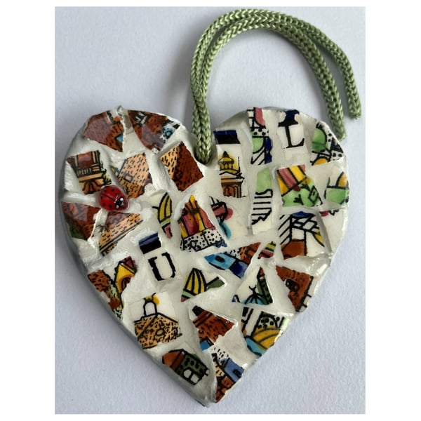 A lovely heart shaped mosaic pendant a brown, blue, green theme.